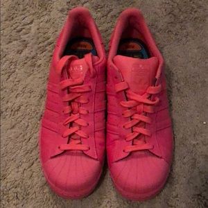 Pink Adidas by Pharrell Superstar sneakers